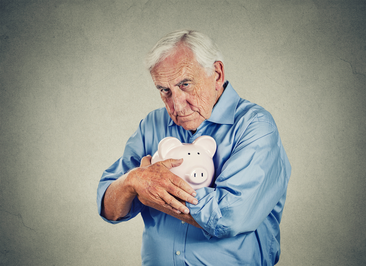 Senior-man-holding-piggy-bank-isolated-on-gray-wall-background-669346868_1204x874.jpeg
